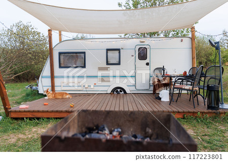 Caravan or camper trailer with Wooden Deck at Countryside Glamping Site. Outdoor Camping 117223801