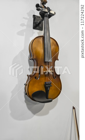 Violin, musical instrument hanging on gray wall. Classical, Violin, musical instrument hanging on gray wall. Classical, 117224292