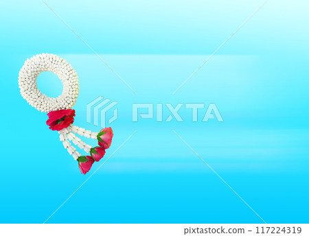 Thai jasmine garland symbolizing Mother's Day in Thailand to offer to monks or Buddhas on blue background. Thai jasmine garland symbolizing Mother's Day in Thailand to offer to monks or Buddhas on blue background. 117224319