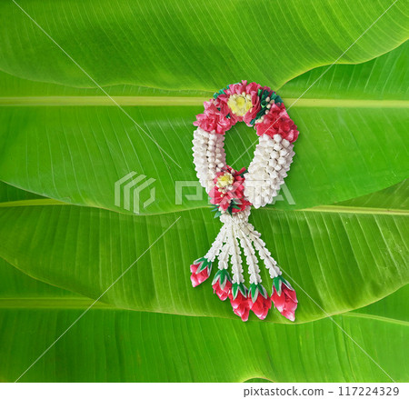 Handmade jasmine garland, a symbol of Mother's Day in Thailand. on banana leaf background 117224329