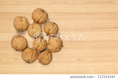 Walnuts on wooden background. Top view. Walnuts on wooden background. Top view. 117224345