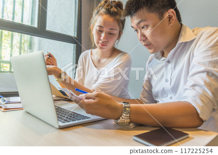 Young business team discuss about information on laptop Young business team discuss about information on laptop 117225254