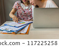Close up of woman pointing pie chart document in discussion 117225258