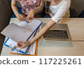 Close up of woman hand pointing at business graph document 117225261