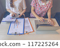 Close-up photo of women hands using laptop tablet while working 117225264