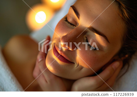 Morning Serenity: Woman Blissfully Receiving Rejuvenating Massage 117226939