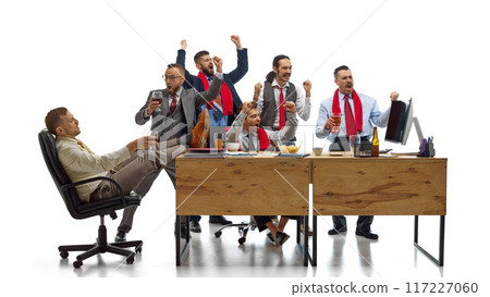 Soccer fans watching game and raising hands, shouting of joy their favorite team scoring goal against white studio background. 117227060