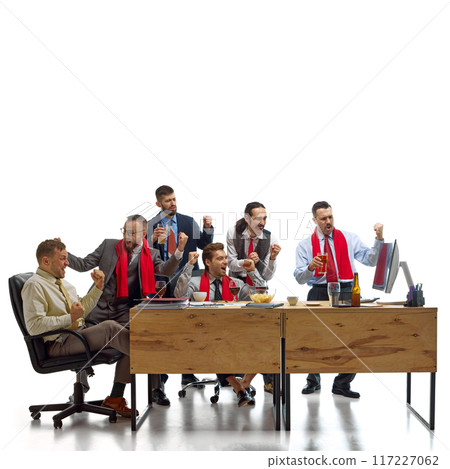 Triumphant group of men watching football match and drinking beer, shouting of joy while working at office against white studio background. Triumphant group of men watching football match and drinking beer, shouting of joy while working at office against white studio background. 117227062