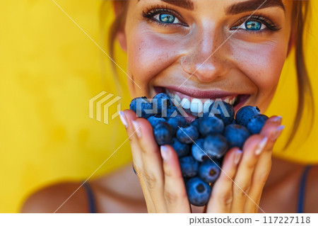 Energetic Fitness Enthusiast Enjoying Fresh Blueberries 117227118