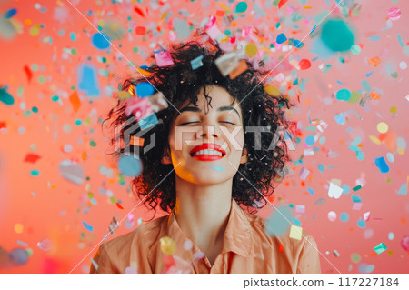 Joyful Woman Embracing Festivity Amidst Confetti Splash Joyful Woman Embracing Festivity Amidst Confetti Splash 117227184