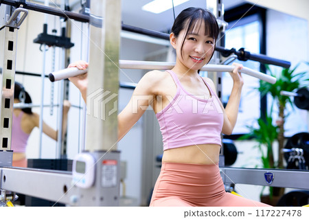 Woman working out at the gym, lat pulldown, female muscle training, workout 117227478