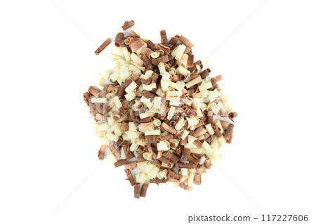Top view of a pile of white and dark chocolate chips on a white background. 117227606