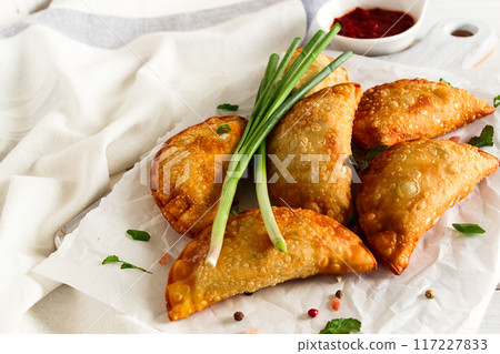 Fried chebureks, close-up, on a light background, no people, Fried chebureks, close-up, on a light background, no people, 117227833