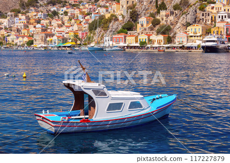 Bright colorful houses on the shore of the bay in the Greek fishing village Symi 117227879