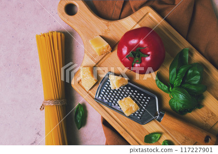 Raw pasta with ingredients, on a beige background, top view, rustic style, selective focus, no people. 117227901