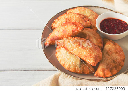 Fried chebureks, close-up, on a light background, no people, 117227903