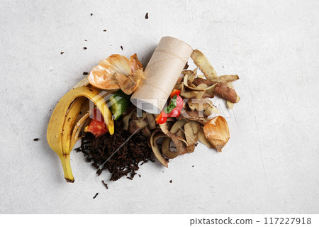 Organic food waste on white background . Vegetable peelings and food leftovers ready to compost. Environmentally responsible behavior, recycling waste concept. top view 117227918