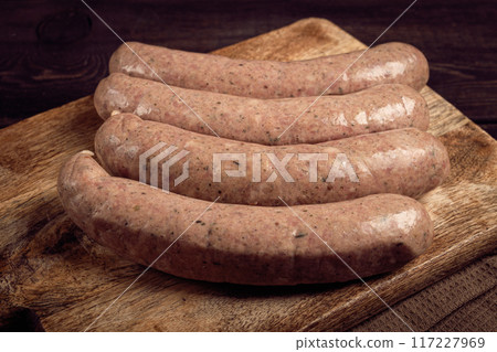 raw sausages in English with bacon, for grilling, on a cutting board, top view, no people, 117227969