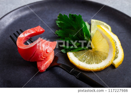 chum salmon, cold smoked, on a fork, with lemon and parsley, top view, close-up, no people, chum salmon, cold smoked, on a fork, with lemon and parsley, top view, close-up, no people, 117227986