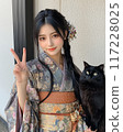 Portrait of a young Japanese woman in a kimono and a black cat 117228025