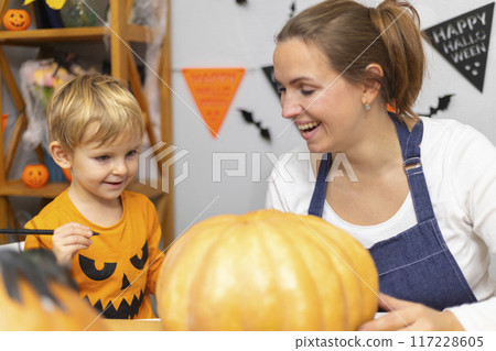 Family Carving Pumpkin for Halloween Celebration 117228605