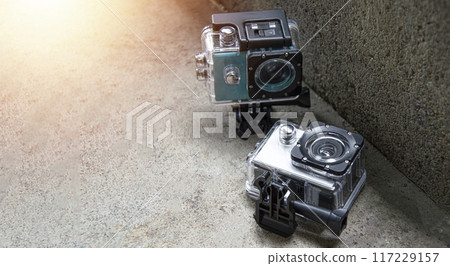 2 action cams placed on the floor, waterproof and dustproof 2 action cams placed on the floor, waterproof and dustproof 117229157