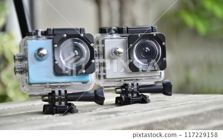 2 action cams placed on the floor, waterproof and dustproof 2 action cams placed on the floor, waterproof and dustproof 117229158