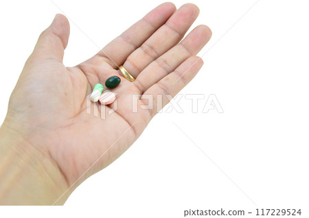 A hand with a pill on it, with clipping path A hand with a pill on it, with clipping path 117229524