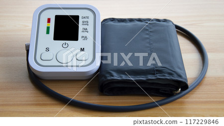 Blood pressure monitor placed on a wooden floor 117229846