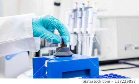Close up of a woman shaking samples using a vortex mixer before HPLC analysis Close up of a woman shaking samples using a vortex mixer before HPLC analysis 117229852