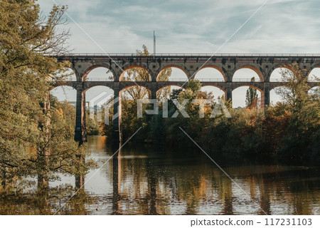 Railway Bridge with river in Bietigheim-Bissingen, Germany. Autumn. Railway viaduct over the Enz River, built in 1853 by Karl von Etzel on a sunny summer day. Bietigheim-Bissingen, Germany. Old 117231103