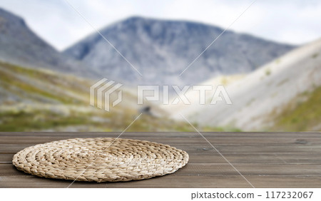 Dark wooden table top with napkin and free space for installing a product or layout Dark wooden table top with napkin and free space for installing a product or layout 117232067