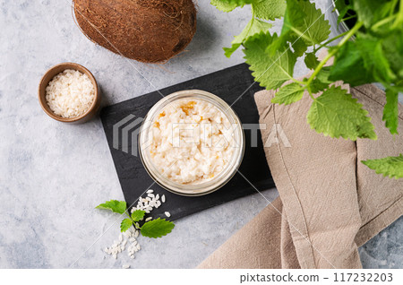 Rice porridge with coconut milk and mango slices in a jar on a light  background.  117232203