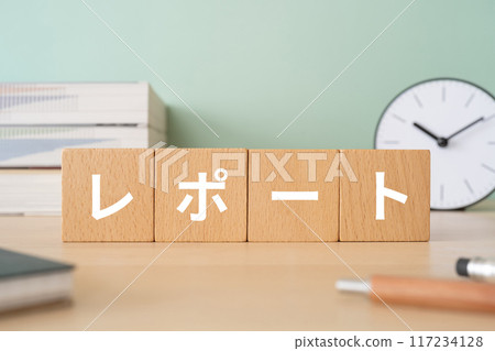 A desk with blocks with the word "report" written on them A desk with blocks with the word "report" written on them 117234128