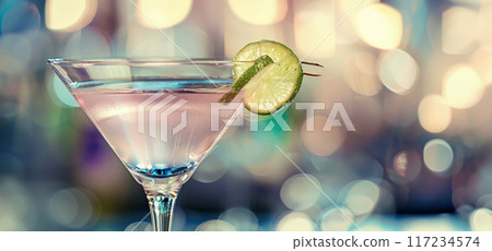 A refreshing lime martini garnished with a lime slice, set against a colorful bokeh background, A refreshing lime martini garnished with a lime slice, set against a colorful bokeh background, 117234574