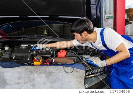 Repairman auto mechanic check for damage inside engine. 117234996