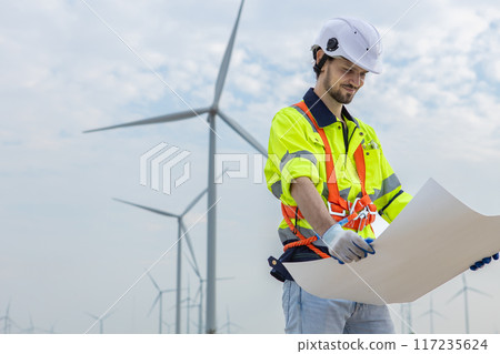 man engineer worker wearing safety uniform holding and reading blueprint man engineer worker wearing safety uniform holding and reading blueprint 117235624