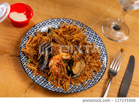 Pasta with seafood contains tiger prawns, shell mussels, spices and white sauce Pasta with seafood contains tiger prawns, shell mussels, spices and white sauce 117235806