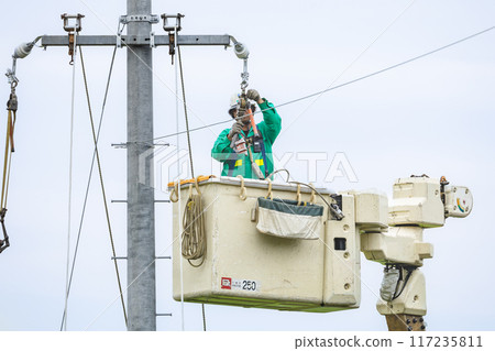 Outdoor electrical work: Power line construction work in progress Outdoor electrical work: Power line construction work in progress 117235811