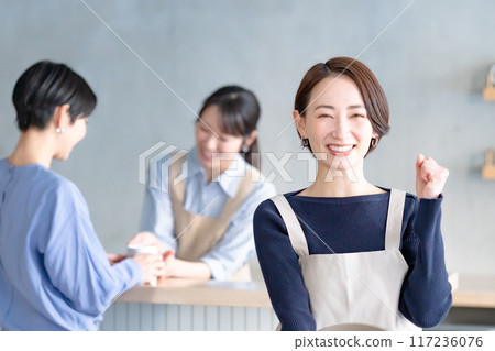 A woman working in a cafe A woman working in a cafe 117236076
