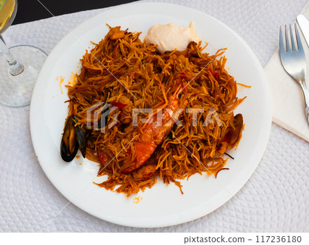 Pasta with seafood contains tiger prawns, shell mussels, spices and white sauce Pasta with seafood contains tiger prawns, shell mussels, spices and white sauce 117236180