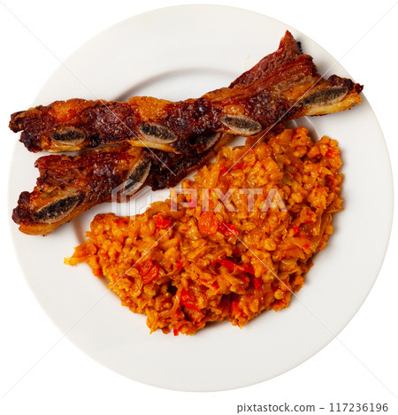 Delicious churrasco style grilled veal ribs served on plate with stewed cabbage with pearl barley porridge. Spain dish 117236196