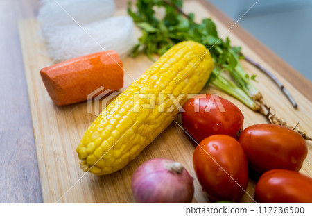 Cutting board with ingredients for preparing spicy glass noodle salad Cutting board with ingredients for preparing spicy glass noodle salad 117236500