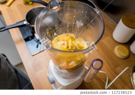 Chef at the kitchen preparing pumpkin porridge with tofu and vegetables 117236523