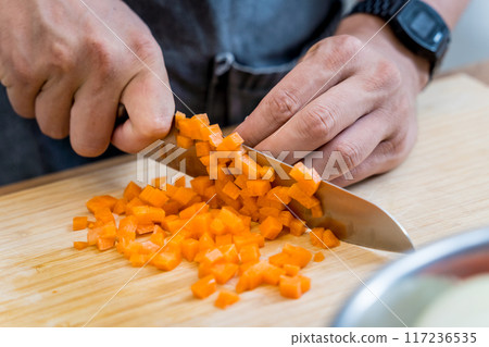 Chef at the kitchen preparing healthy quinoa bowl with avocado 117236535