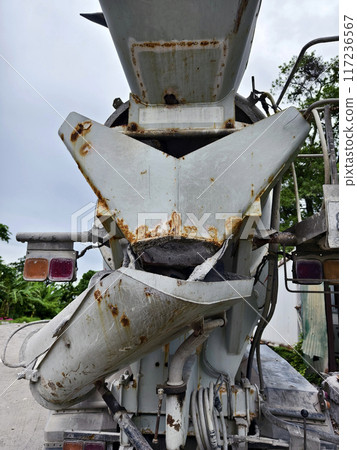 A concrete mixer truck parked beside of a concrete factory A concrete mixer truck parked beside of a concrete factory 117236567