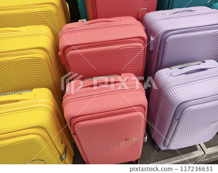 A vibrant assortment of suitcases is carefully arranged in a pile A vibrant assortment of suitcases is carefully arranged in a pile 117236631