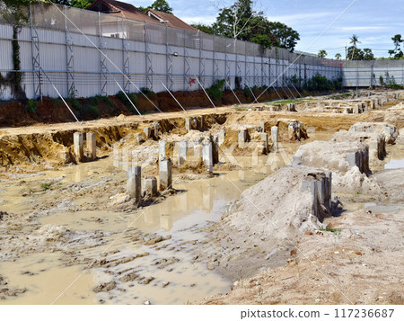 Many piles in the middle of a construction site Many piles in the middle of a construction site 117236687