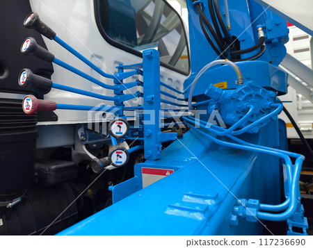Truck featuring several blue buttons on its interface for crane control 117236690