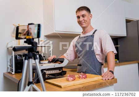 The chef is broadcasting live from workshop how to prepare a beef steaks on the electric grill The chef is broadcasting live from workshop how to prepare a beef steaks on the electric grill 117236702